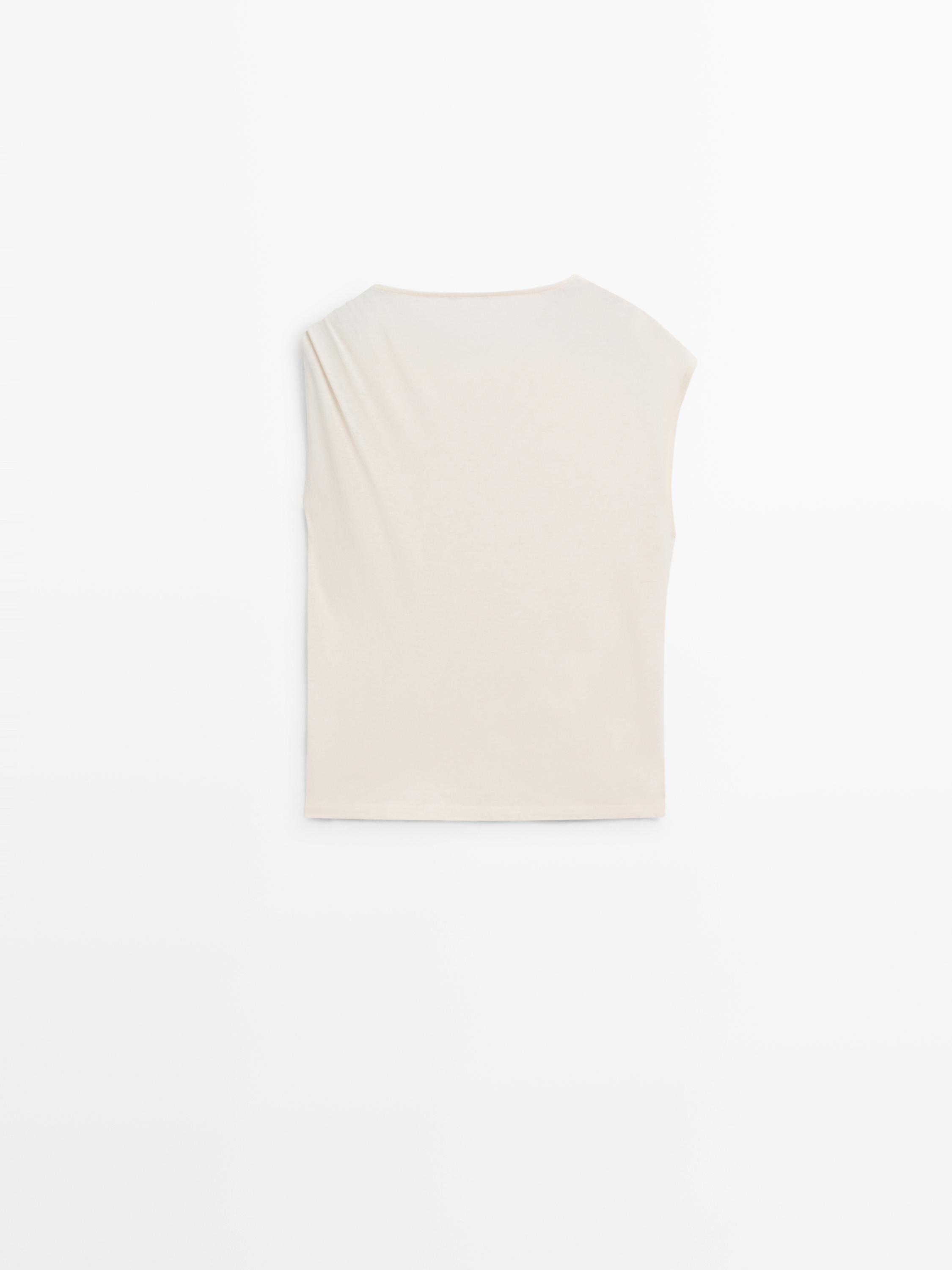 Asymmetric top with shoulder appliqué